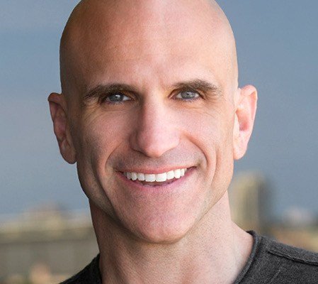 A smiling bald headed man. Smith Publicity book marketing