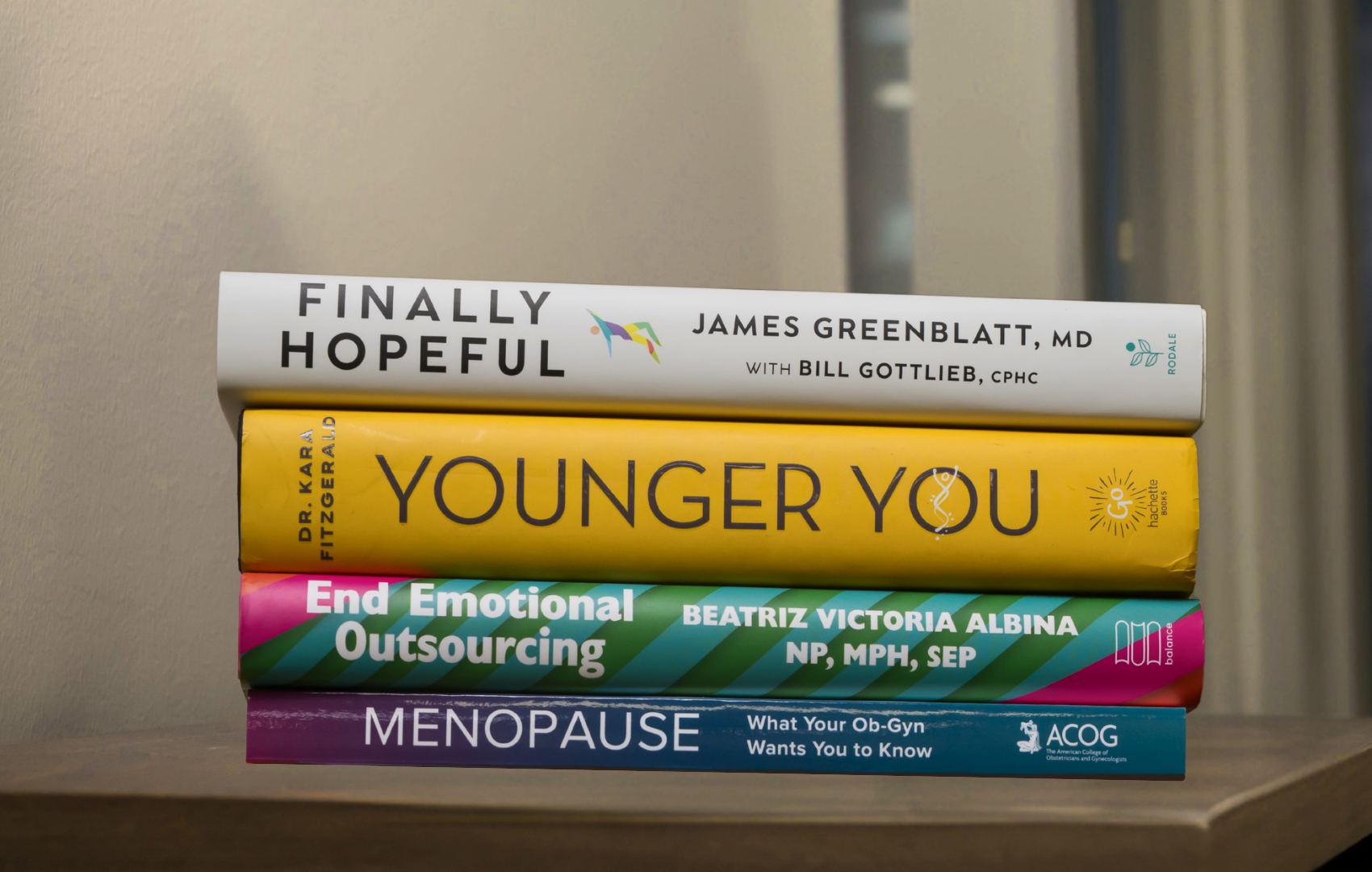 a book stack of four books on lifestyle and wellness